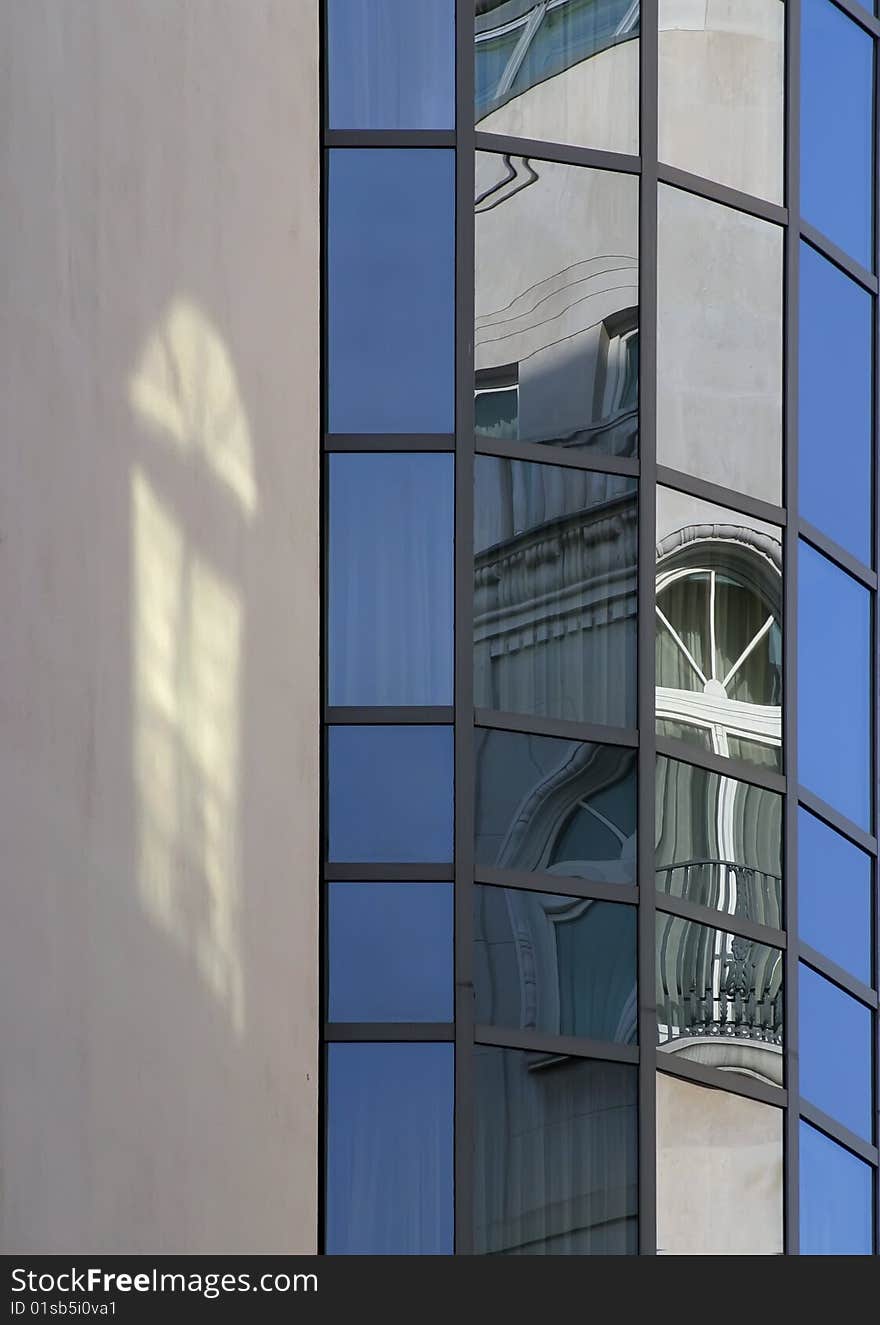 The modern office block is the old house's malformed image on his windows. The modern office block is the old house's malformed image on his windows.