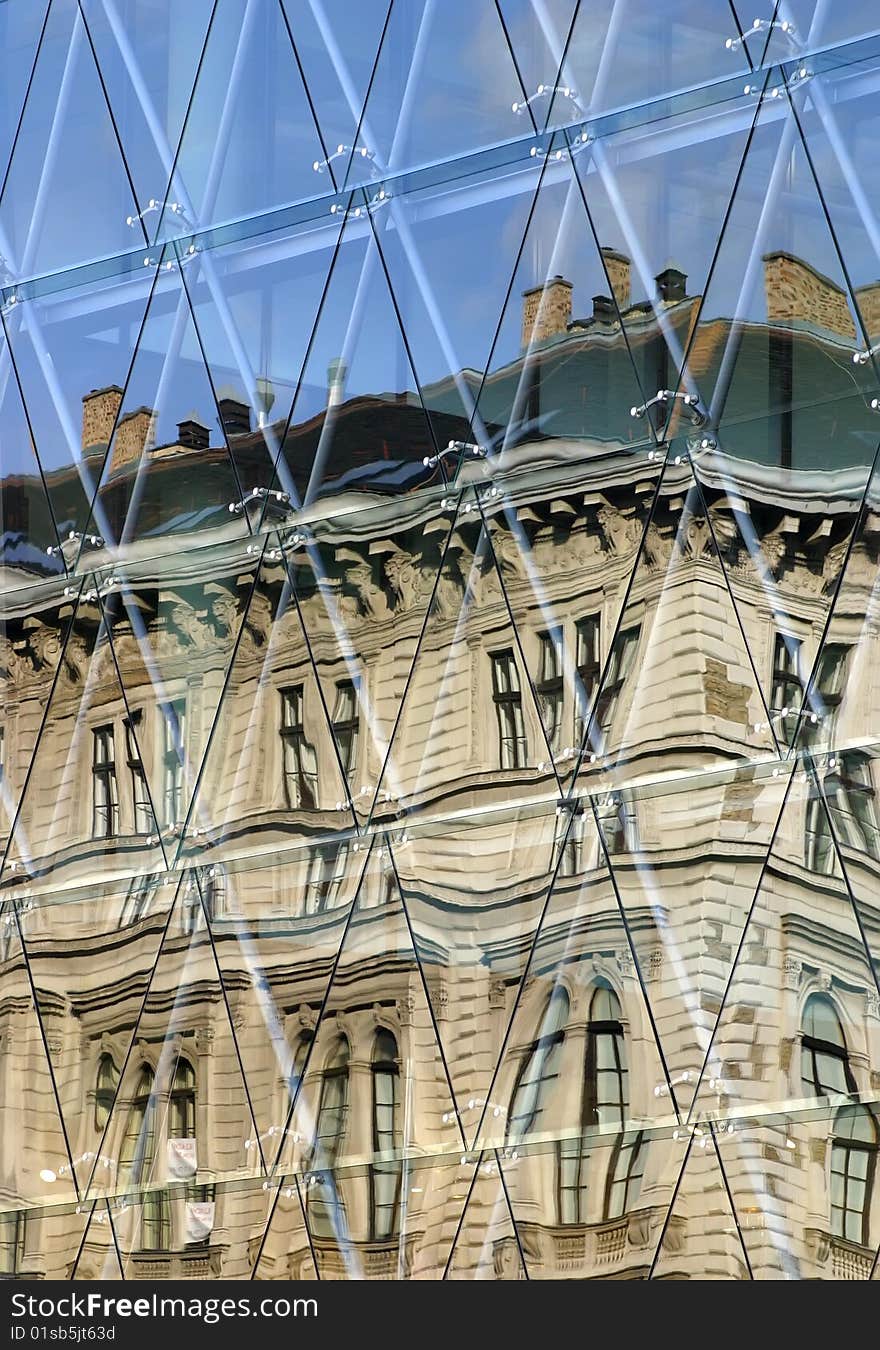 The modern office block is the old house's malformed image on his windows. The modern office block is the old house's malformed image on his windows.