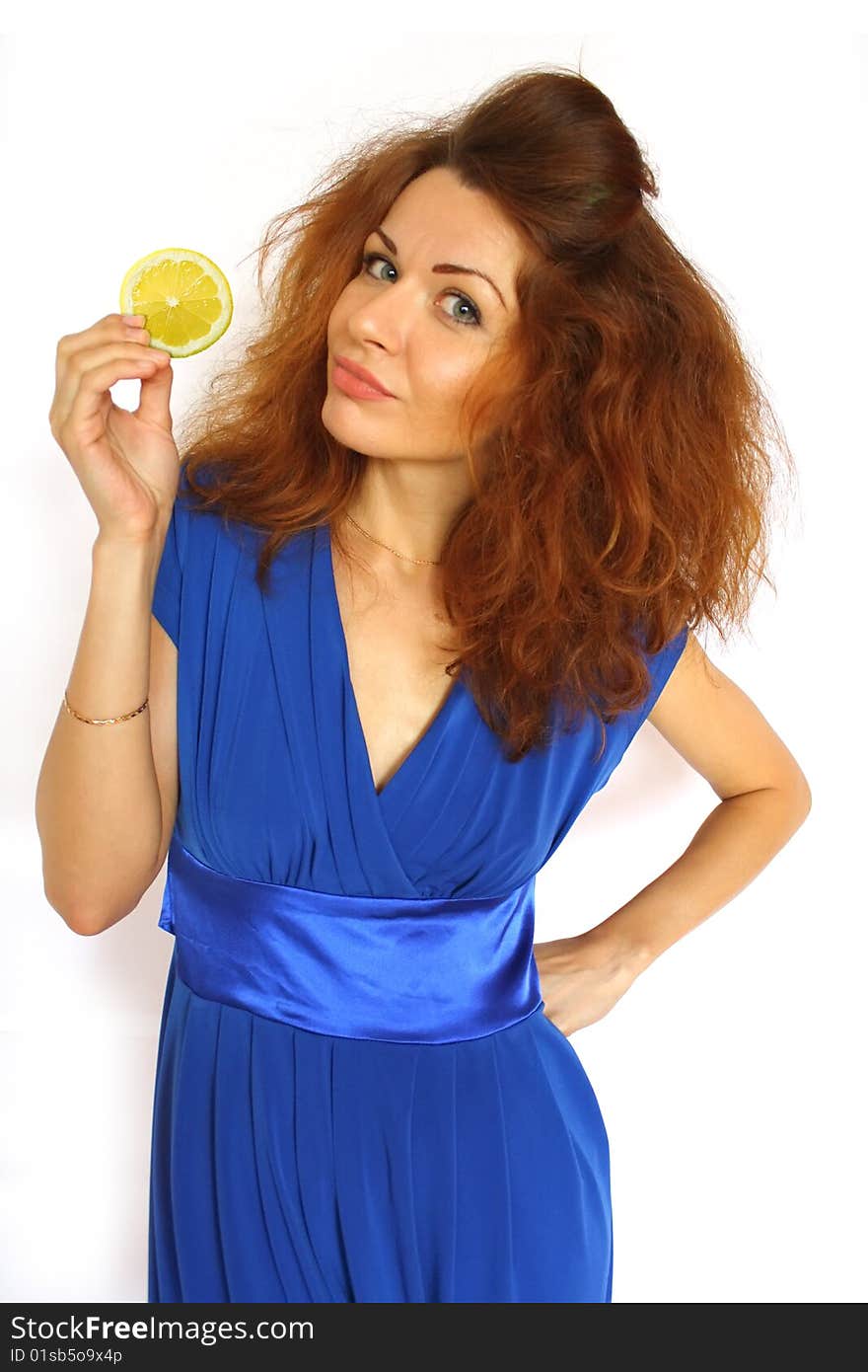 Red-haired girl with lemon segment in her arm on white backround. Red-haired girl with lemon segment in her arm on white backround