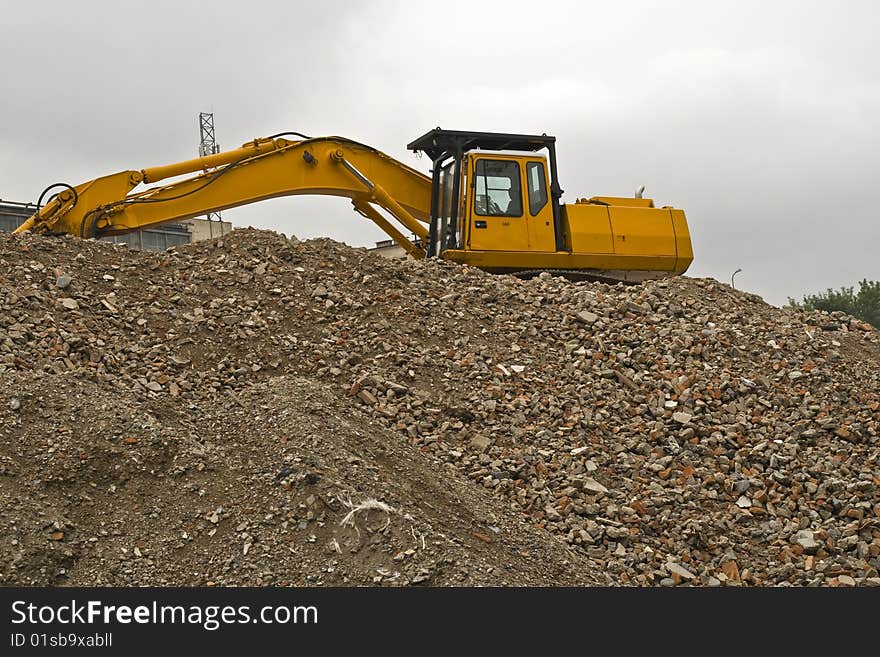 Backhoe is working during demolition of building