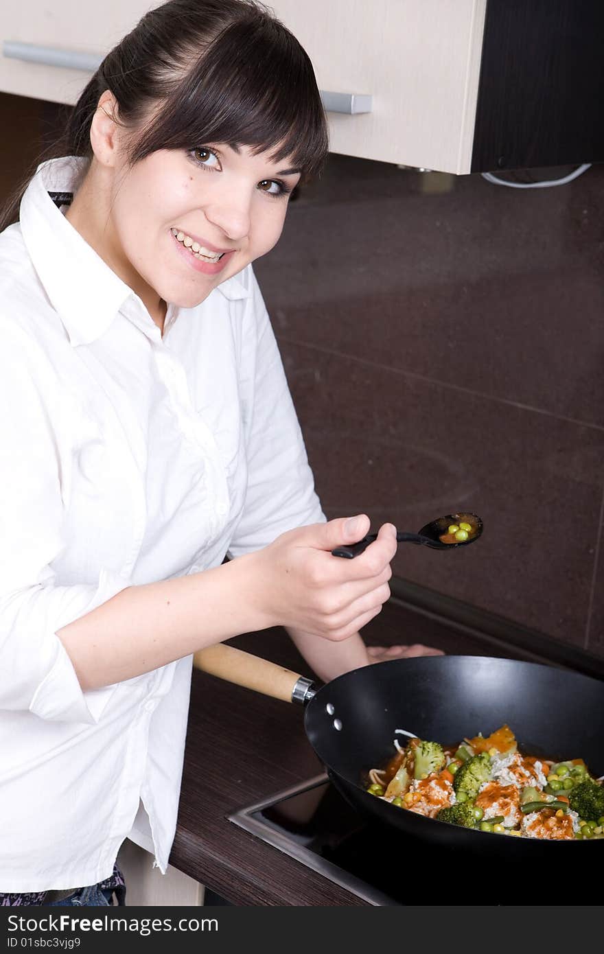 Young happy woman in kitchen. Young happy woman in kitchen