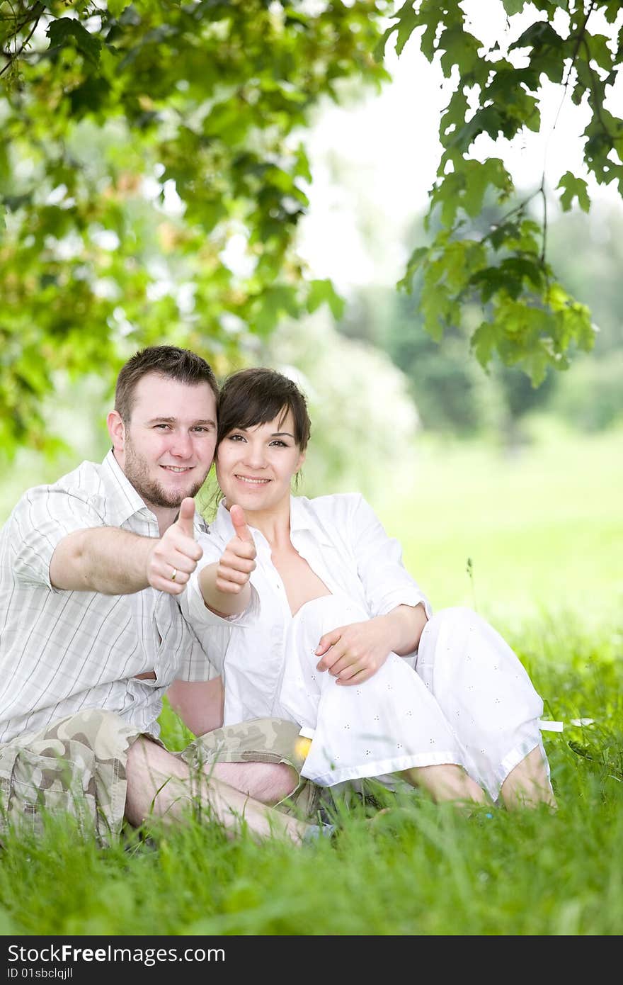 Happy young couple relaxing in park. Happy young couple relaxing in park