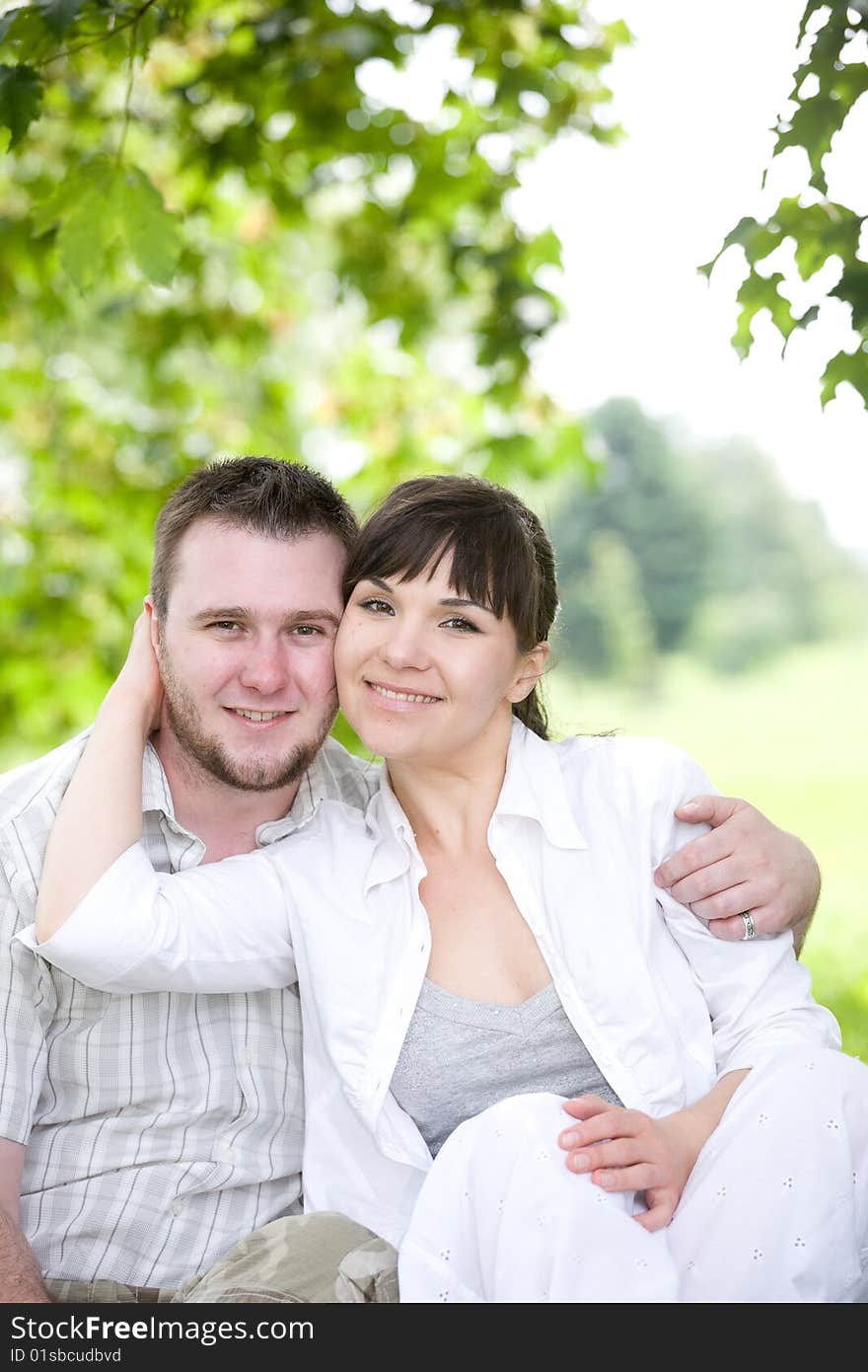 Happy young couple relaxing in park. Happy young couple relaxing in park