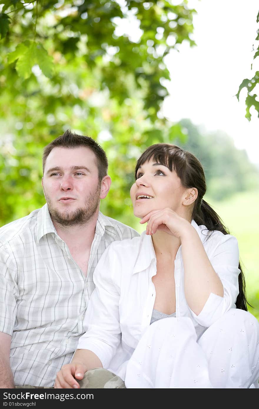 Happy young couple relaxing in park. Happy young couple relaxing in park