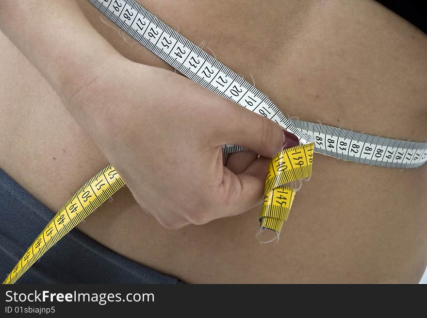 Woman checking out her waist line. Woman checking out her waist line