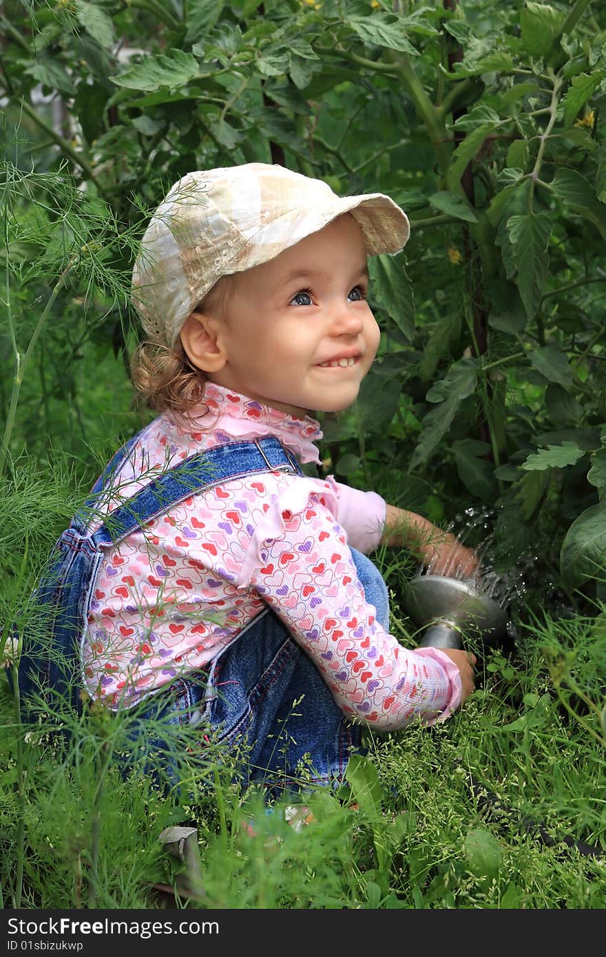 Girl Pours A Vegetable Garden.