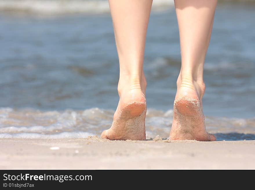 Beautiful legs on beach sand. Beautiful legs on beach sand