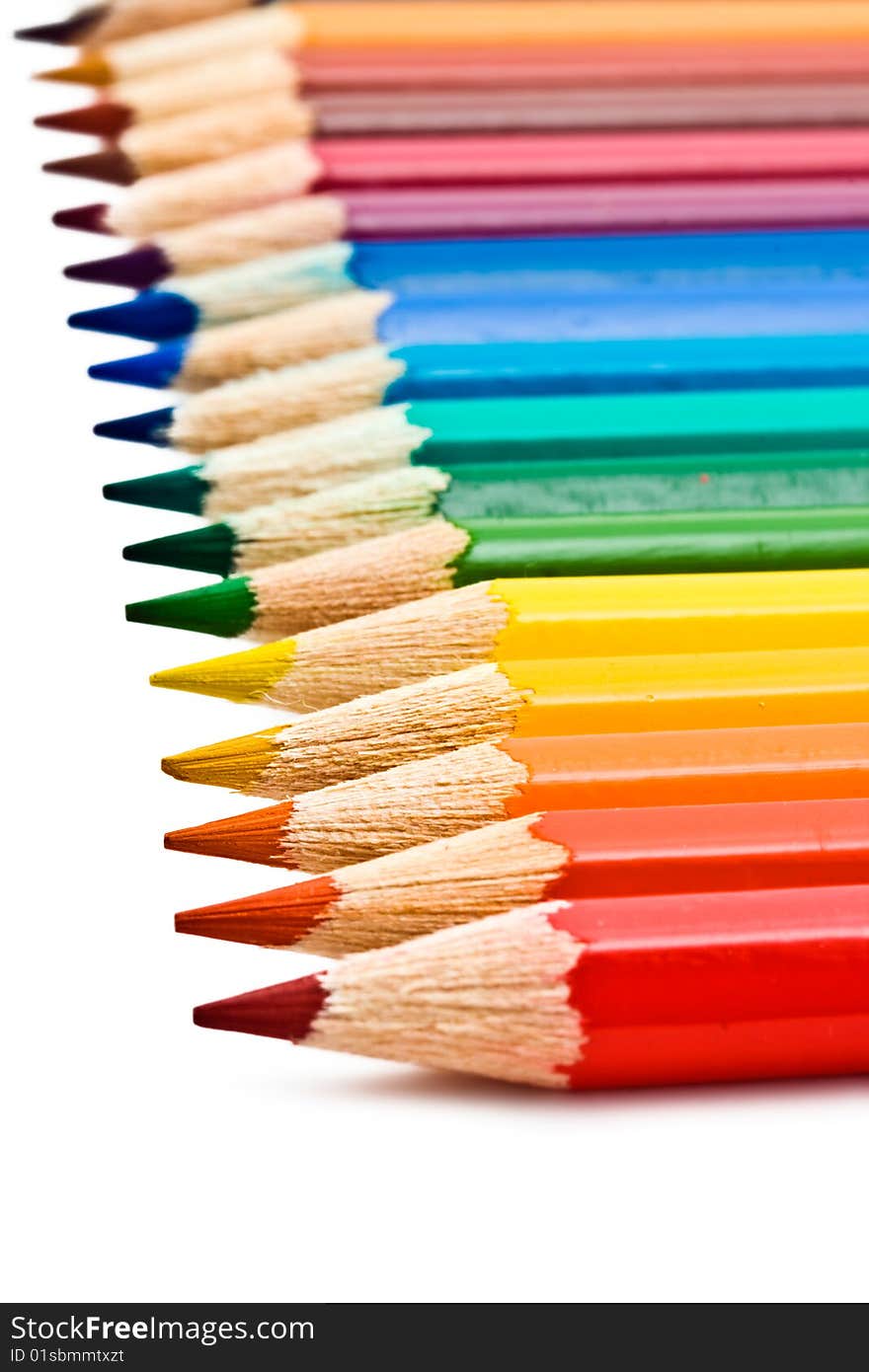 Coloured pencils with shadow on white background