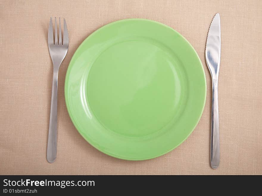 Fork and knife near green plate