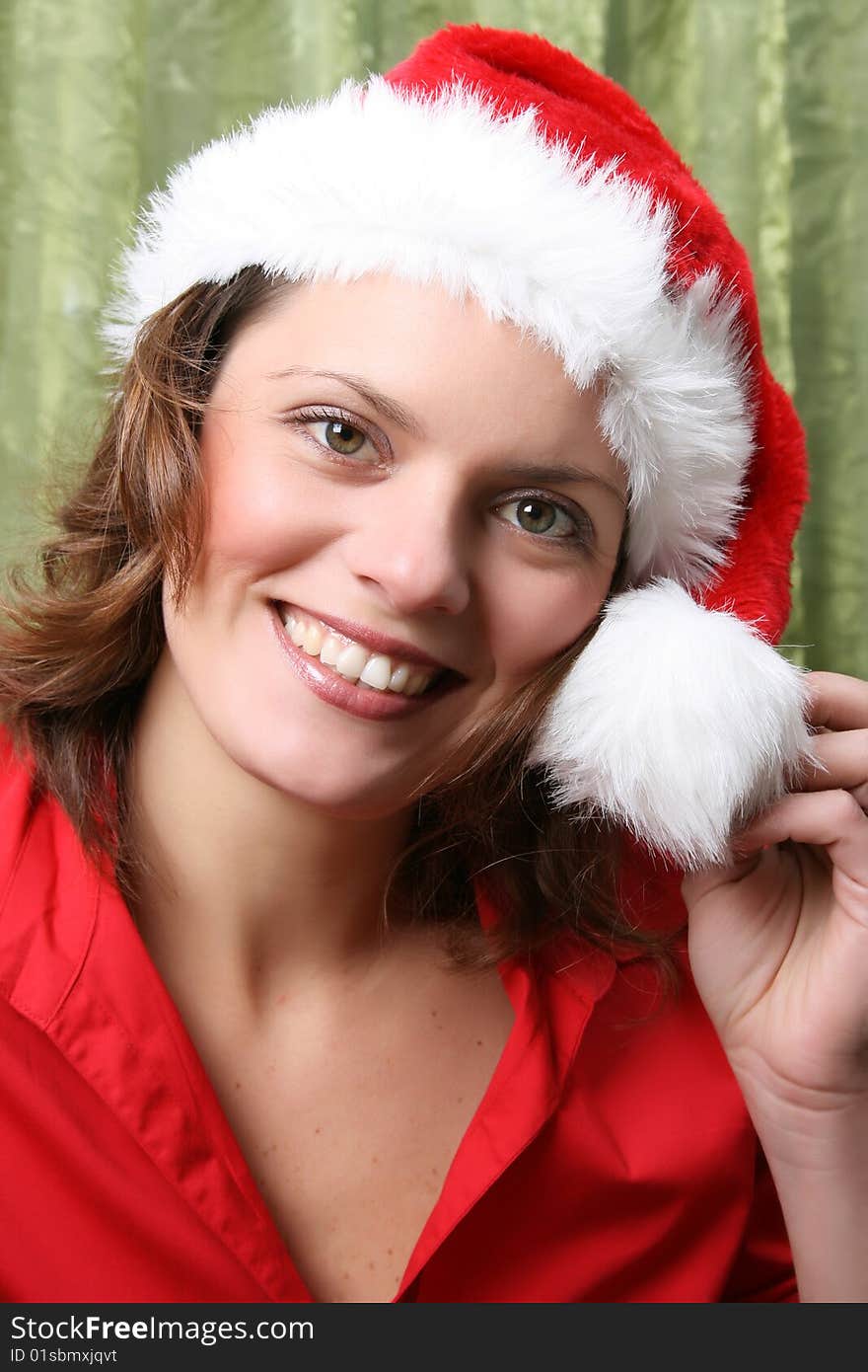 Beautiful Brunette model with a christmas hat and red top. Beautiful Brunette model with a christmas hat and red top