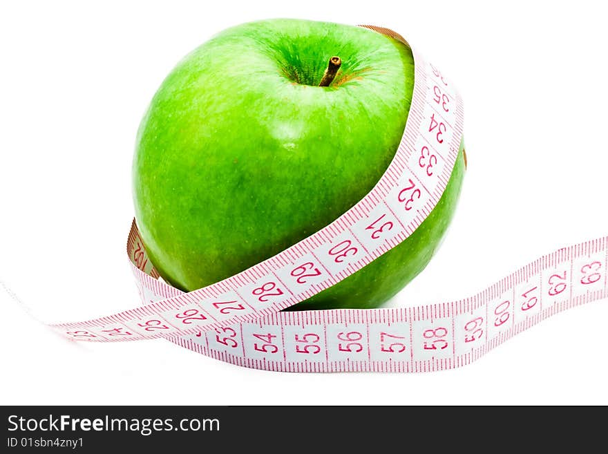 Measuring a green apple on white background