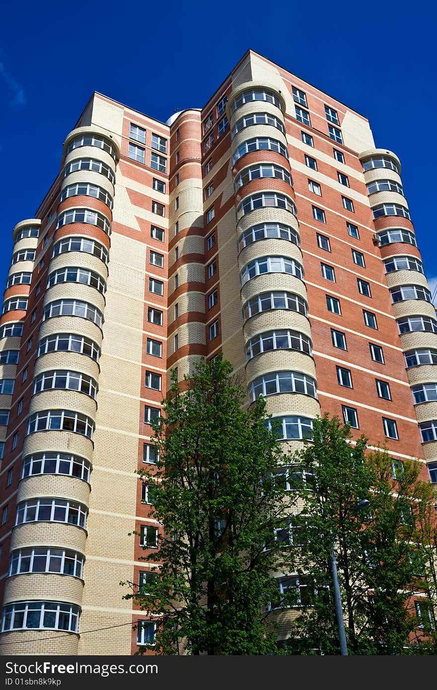 High modern apartment building under blue sky. High modern apartment building under blue sky