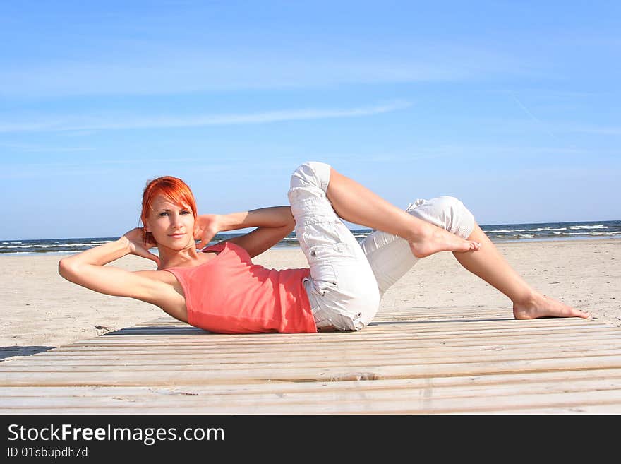 Young woman working out on the beach. Young woman working out on the beach