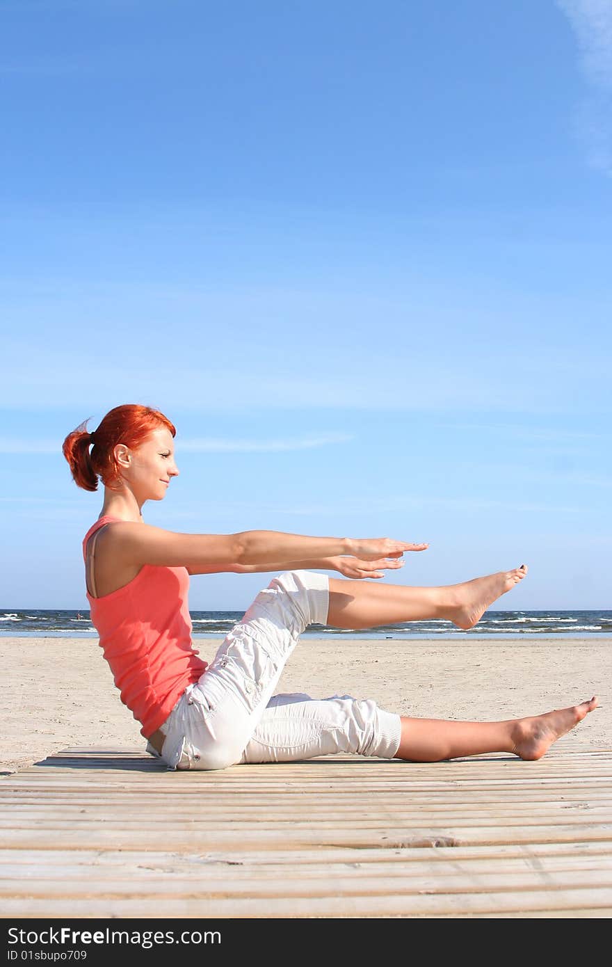 Young woman working out on the beach. Young woman working out on the beach