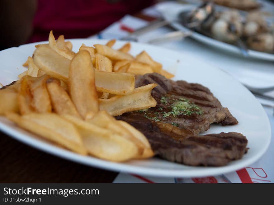 Frencn meal with beef and golden potato fries. Frencn meal with beef and golden potato fries