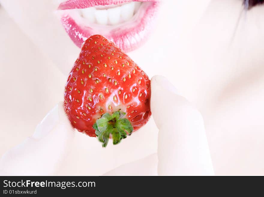 Close up of woman eating a strawberry. Close up of woman eating a strawberry