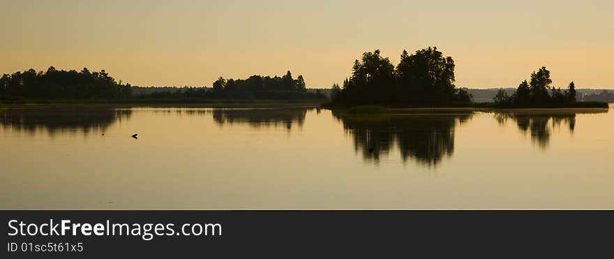 Warm reflection on a summer morning of Boulder Lake Minnesota