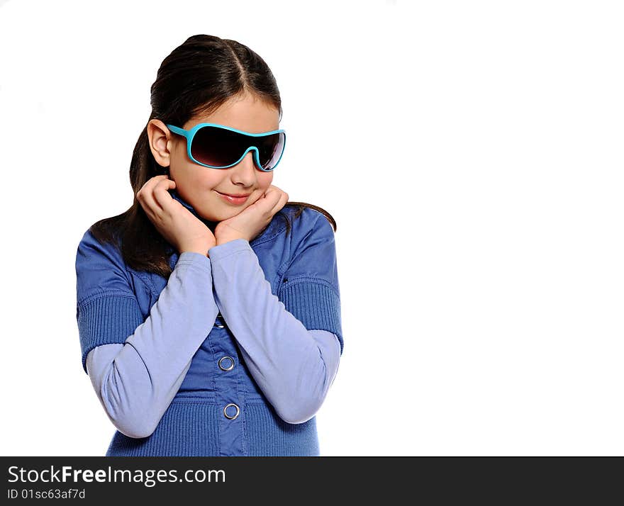 Cute girl in blue outfit and blue sunglasses resting head on hands, isolated