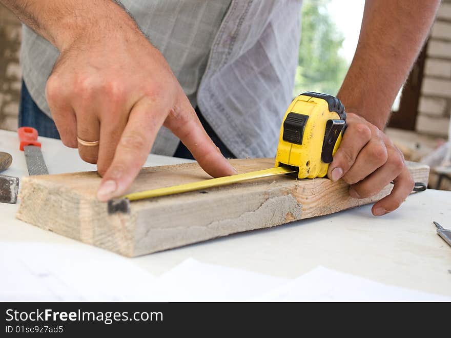 Measuring of wood board close-up