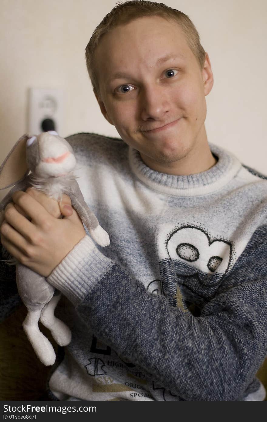 The boy holds a toy - a rabbit out of the cartoon Hunting Season. The boy holds a toy - a rabbit out of the cartoon Hunting Season