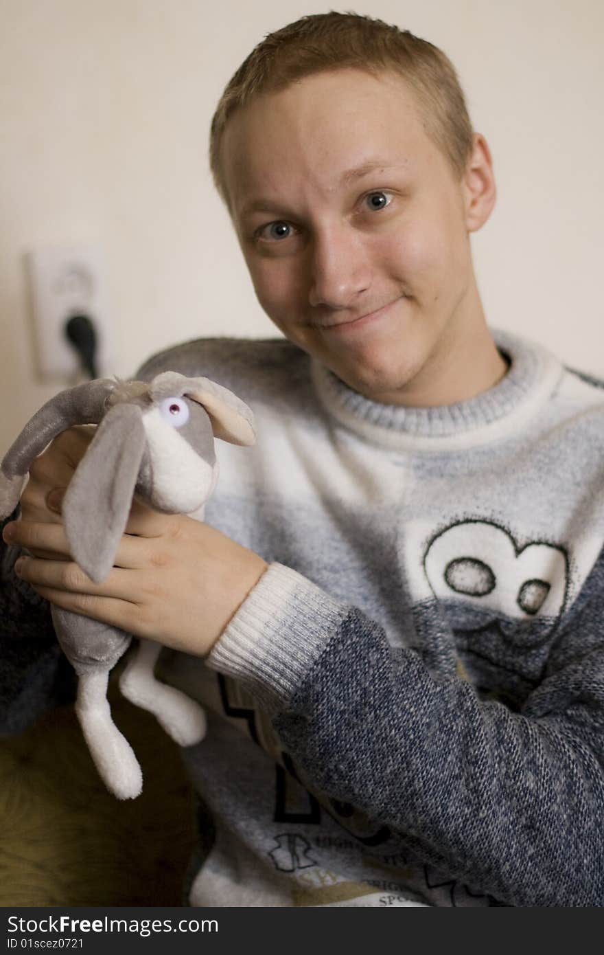 The boy holds a toy - a rabbit out of the cartoon Hunting Season. The boy holds a toy - a rabbit out of the cartoon Hunting Season