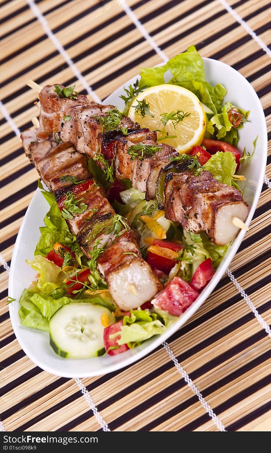 Grilled chicken kebab served with a fresh salad