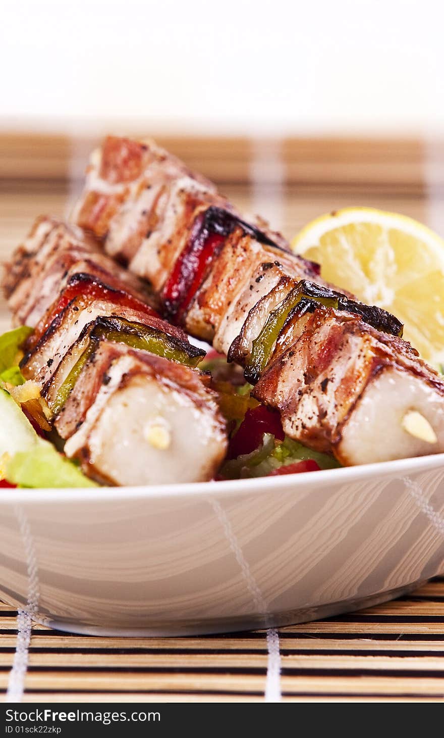 Grilled chicken kebab served with a fresh salad