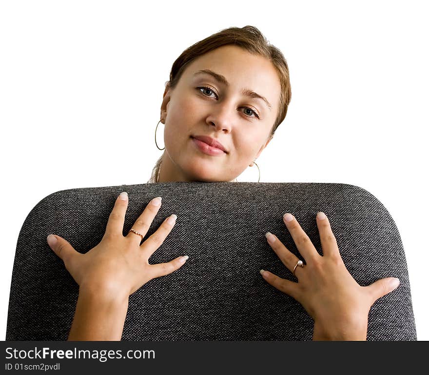 Girl embraces a back of a chair from an underside. Girl embraces a back of a chair from an underside