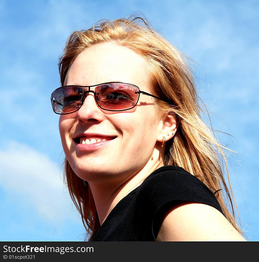 A young, blond woman with sun glasses. A young, blond woman with sun glasses