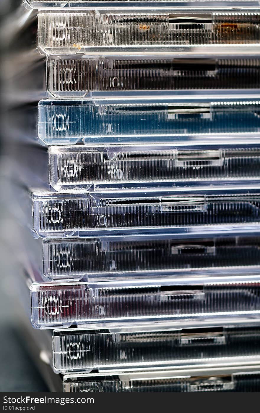 A close up of a stack of CDs in plastic cases