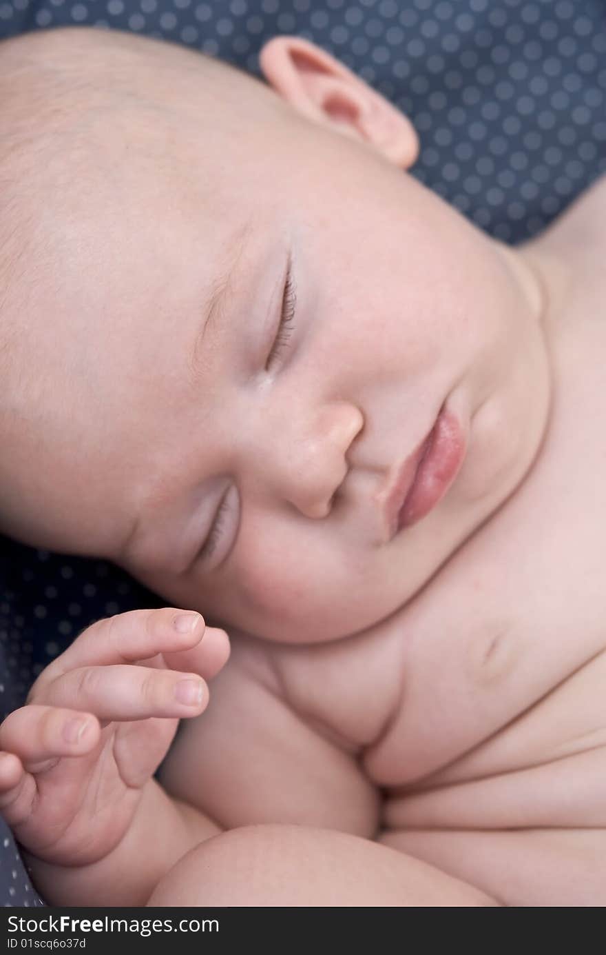 A precious baby sound asleep in an awkward position, focus on the hand. A precious baby sound asleep in an awkward position, focus on the hand.