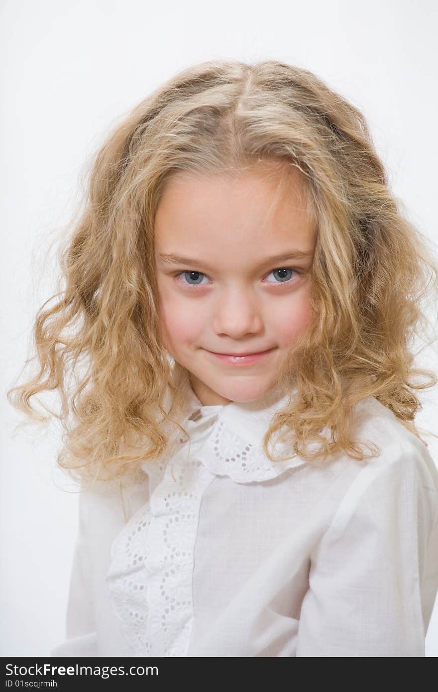 Portrait of the attractive little girl on a white background