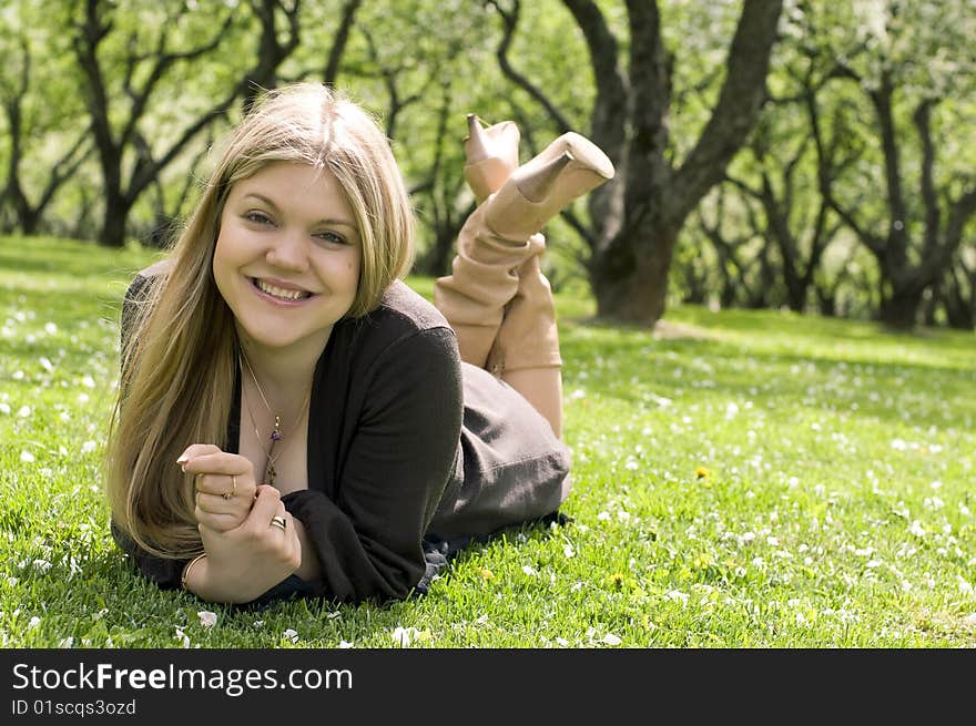 Smiling woman with blond hair relaxing in the park