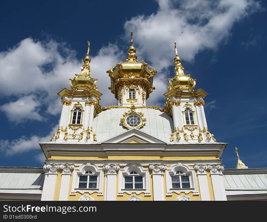 Type gold domes Museum in Peterhof on the background of the sky. 
Peterhof, the famous seat of St. Petersburg, Peter I park