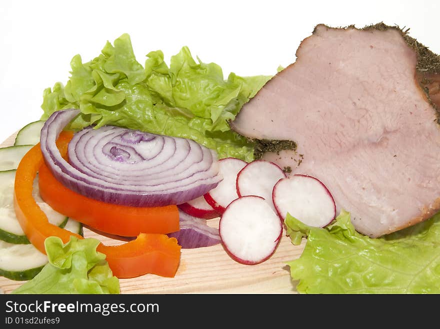 Portion of meat with vegetables on the white background