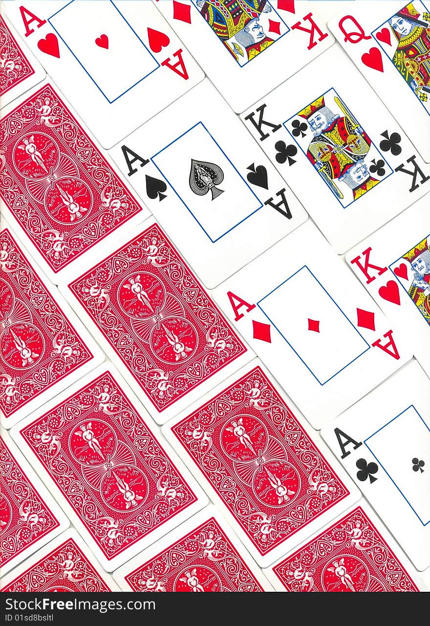 Background of the inverse of playing cards of different colors on the table isolated on white