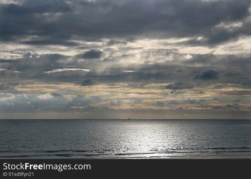 Sun on the beach with a boat in the horizon. Sun on the beach with a boat in the horizon