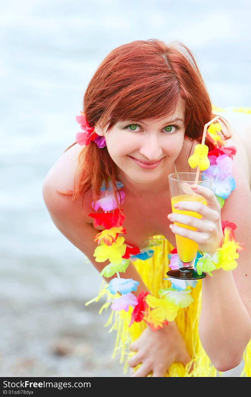 Attractive girl with glass of juice on sea background