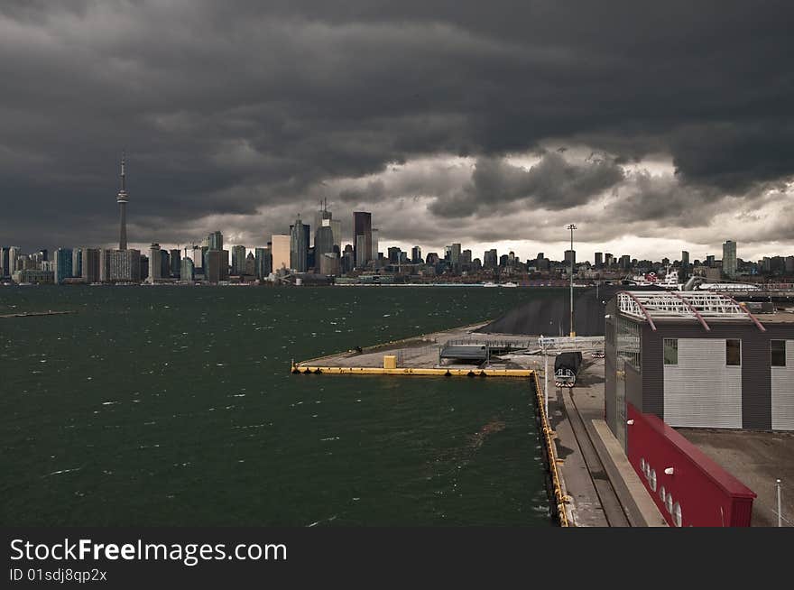 A rain storm is darkening the cityscape of Toronto. 
Seen from an elevated point at the cruise terminal. A rain storm is darkening the cityscape of Toronto. 
Seen from an elevated point at the cruise terminal