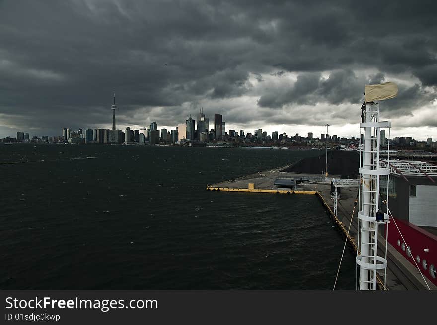 A rain storm is darkening the cityscape of Toronto. 
Seen from an elevated point at the cruise terminal. A rain storm is darkening the cityscape of Toronto. 
Seen from an elevated point at the cruise terminal