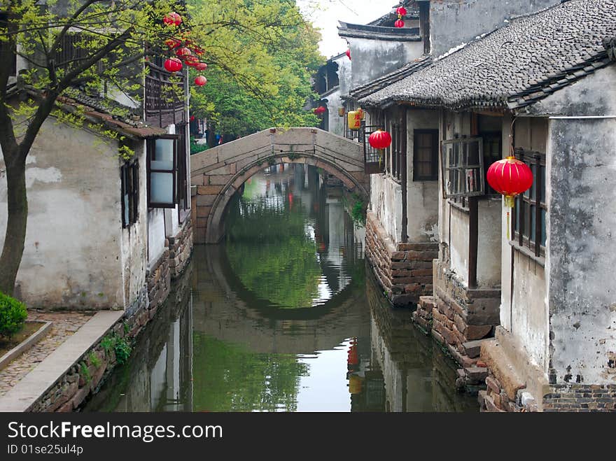 A bridge with its reflection make a beautiful sense in Chinese old water towm .