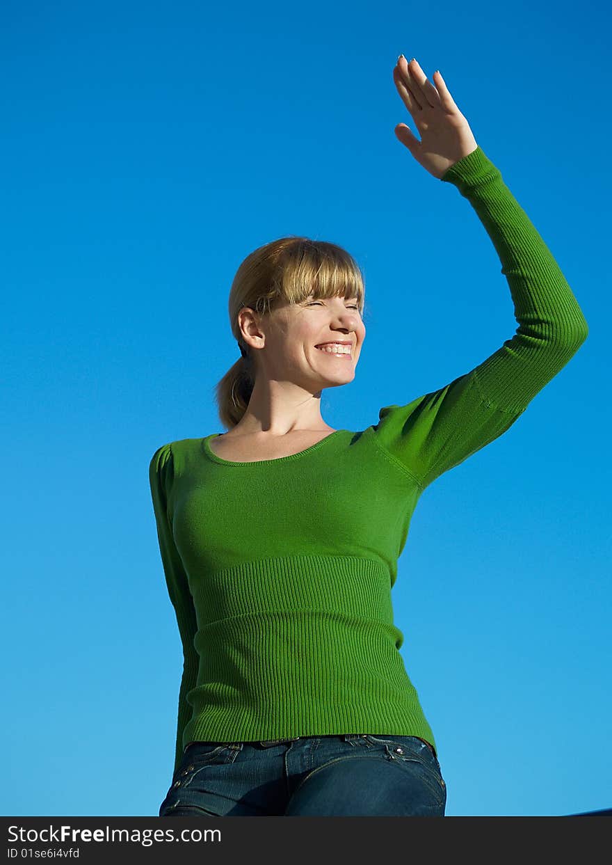 Portrait of the young woman posing on a background of the dark blue sky. Portrait of the young woman posing on a background of the dark blue sky