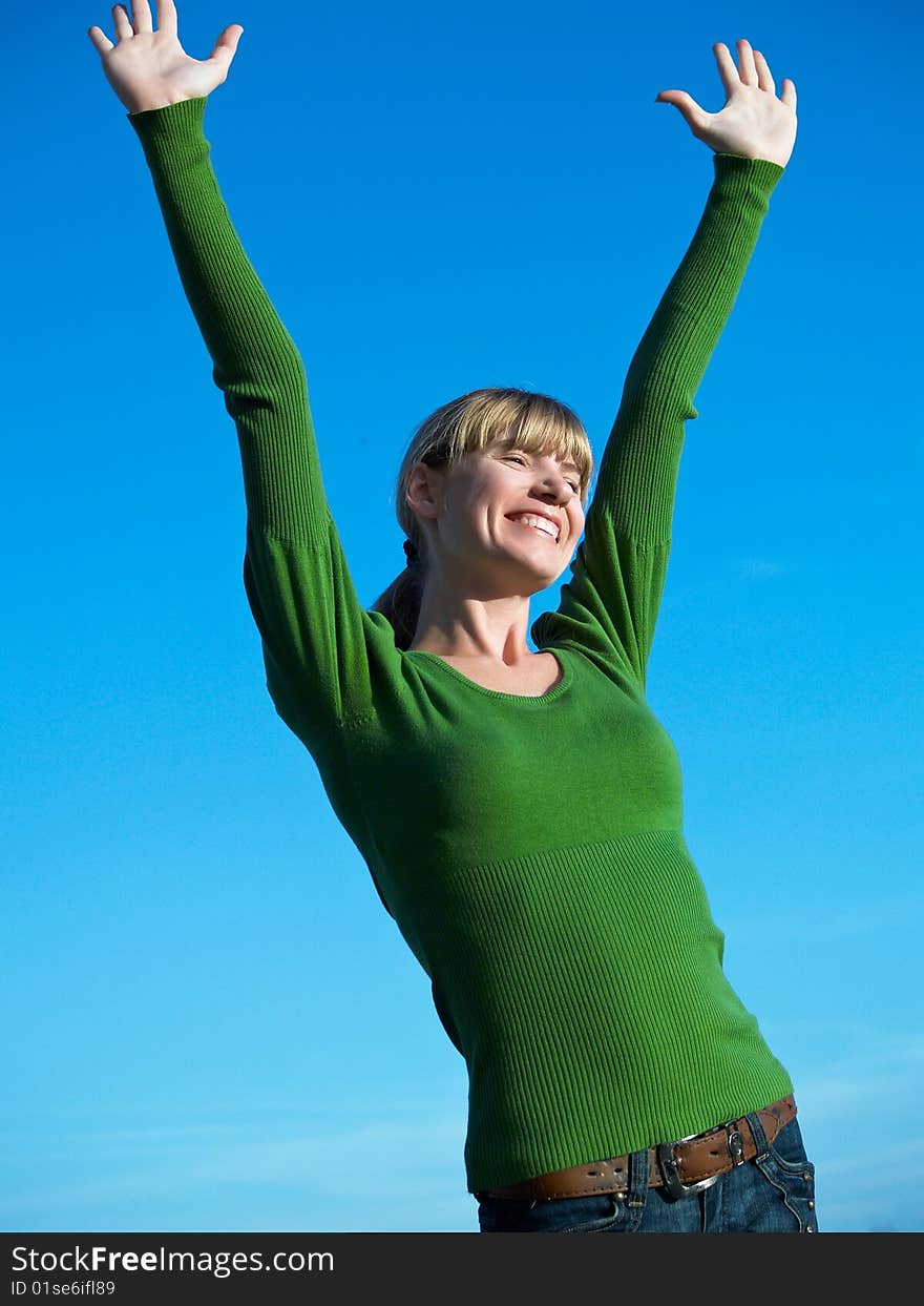 Portrait of the young woman posing on a background of the dark blue sky. Portrait of the young woman posing on a background of the dark blue sky