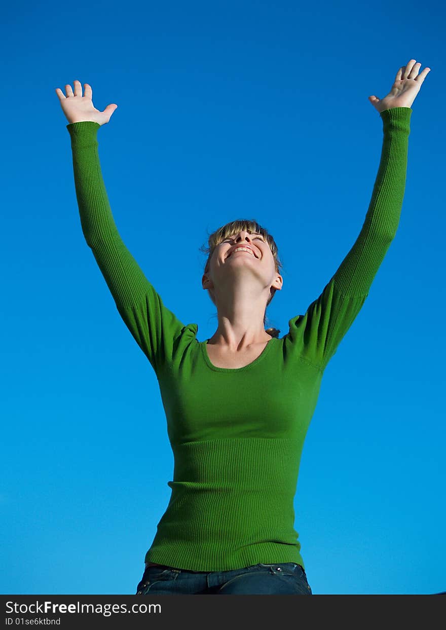 Portrait of the young woman posing on a background of the dark blue sky. Portrait of the young woman posing on a background of the dark blue sky