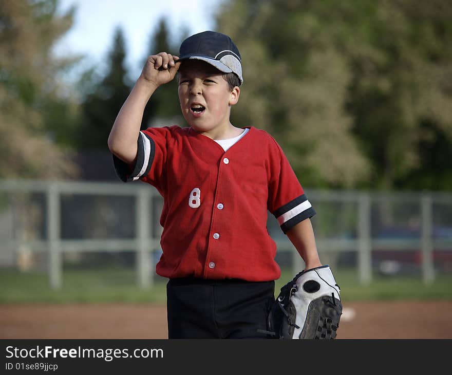 This young baseball player puts lots of energy into the game and claims he is the best player on the team. This young baseball player puts lots of energy into the game and claims he is the best player on the team.