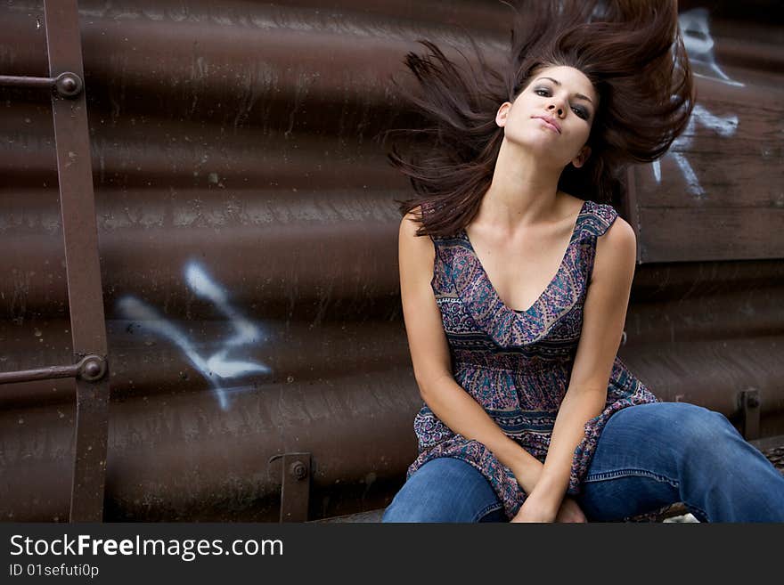 A Beautiful Model sitting with a brown background