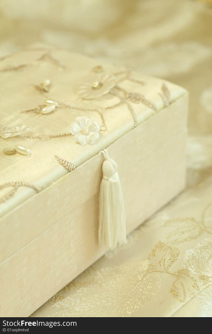 Beautiful gift box sheathed by silk with an embro