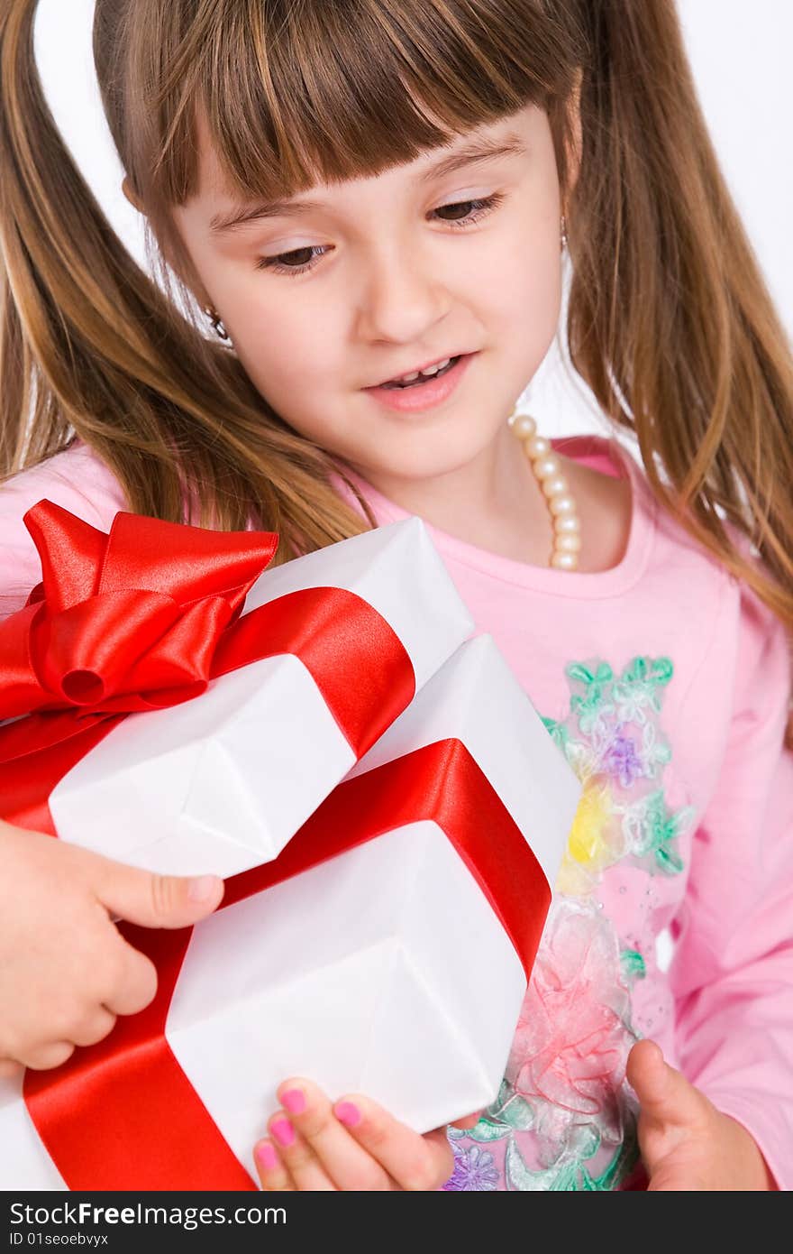 Adorable little girl with white gift box