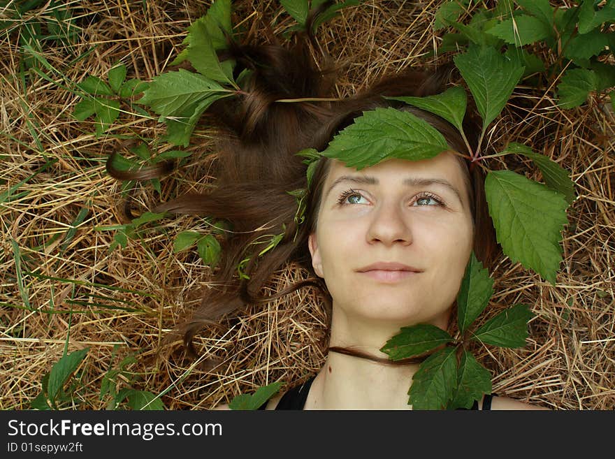 The young girl and leaves of wild grapes. The young girl and leaves of wild grapes