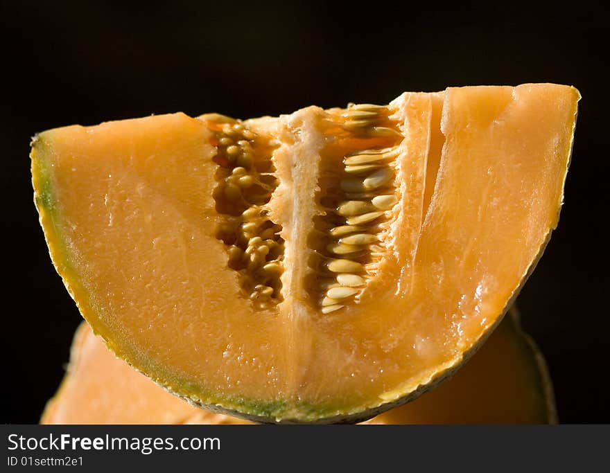 Half a melon on a black background